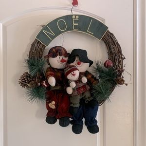 Christmas wreath with stuffed snowman family
